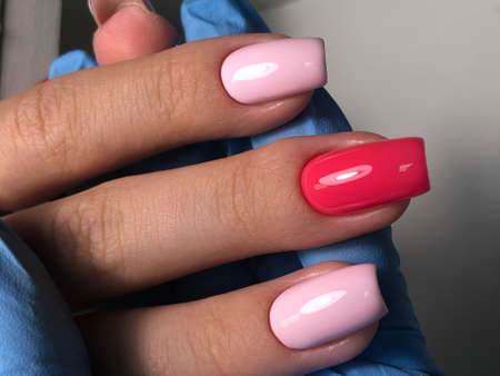 Multicolored manicure close up. Young woman hands with pastel manicure.Bright multi-colored design...