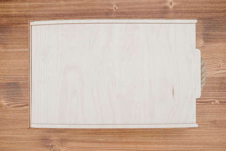 Wooden empty box on wooden background. Top view.Empty wooden box product material - plywood. wood...