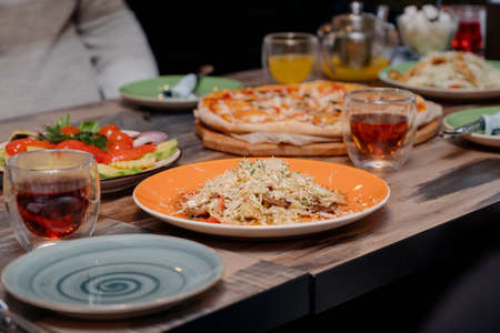 Wooden Table with food and drinks.People talk and eat together during a table meeting