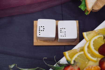 White salt and pepper shakers, top view.White spicery set on the table