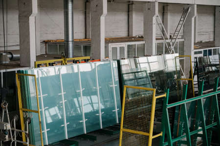 Factory for aluminum and PVC windows and doors production. Details industrial equipment.The process of manufacturing plastic window framesの写真素材