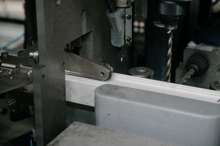 Factory for aluminum and PVC windows and doors production. Details industrial equipment.The process of manufacturing plastic window framesの写真素材