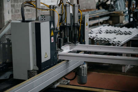 Factory for aluminum and PVC windows and doors production. Details industrial equipment.The process...