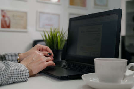 A woman is typing on a laptop keyboard.Close-up view on woman working on laptop