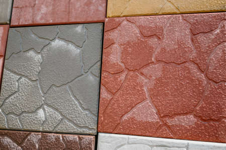 Texture of different colored patterned paving slabs . Modern road surface.Traditional fence, court,...