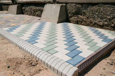 Texture of different colored patterned paving slabs . Modern road surface.Traditional fence, court, backyard or road paving.の写真素材