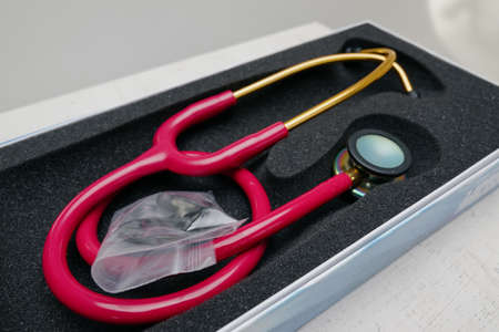 medical stethoscope. Red medical stethoscope.The concept of healthcare.Stethoscope on a dark...