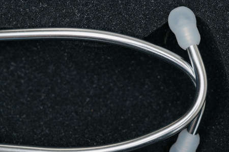 medical stethoscope. White medical stethoscope.The concept of healthcare.Stethoscope on a dark backgroundの写真素材