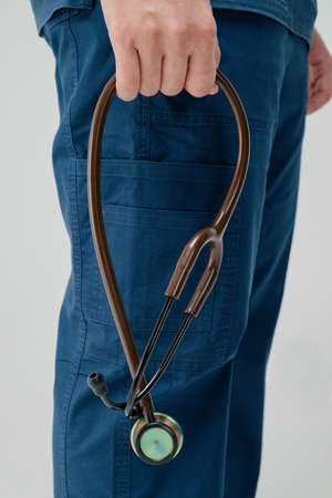 Brown medical stethoscope.A doctor with a stethoscope.A doctor holding a stethoscope.The concept of...