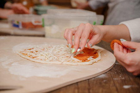 The pizza making process.cCooking homemade pizza. woman cooking a pizza close upの写真素材