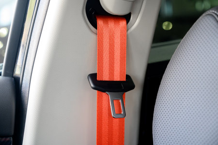 Close-up of a seat belt. Orange seat belt in the interior of a new modern carの写真素材
