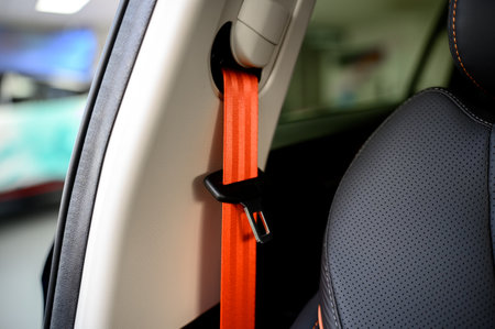 Close-up of a seat belt. Orange seat belt in the interior of a new modern carの写真素材