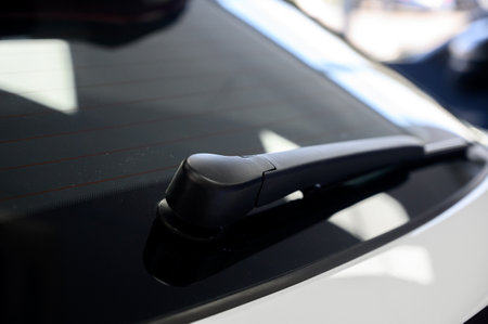 Car rear window wiper. Close-up of rear window wipers on a new car. Rear view of white car with rear wiperの写真素材