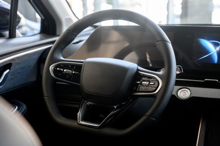 Car interior. Luxurious modern car interior with black leather steering wheel, digital instrument panel and black interior.の写真素材