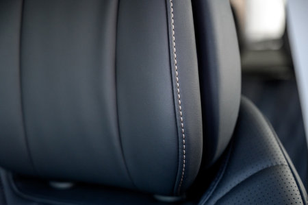 Close-up of black leather seat of modern car. The interior of a modern car with black leather seats.の写真素材