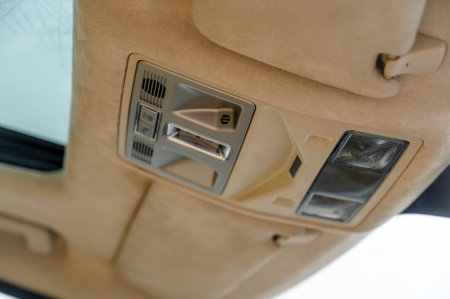 Closeup image of a vehicles overhead control panel showing passenger info and various available controlsの写真素材