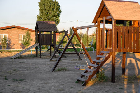 Children's outdoor play complex. Children's slide, swings and playhousesの写真素材