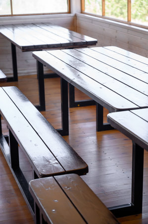 Wooden benches in the interior with wooden walls and floor.Interior space with wooden benches installed on a wooden floor.の写真素材
