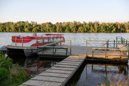 Boat at a wooden pier with a forest in the background. Concept of outdoor recreation, fishing, boat...