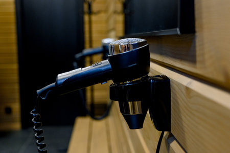 Close-up of a black hair dryer in a locker roomの写真素材