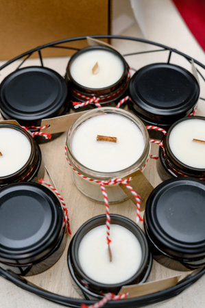 A gift set of candles with wooden wicks in small jars. Handmade candles in glass containers with...