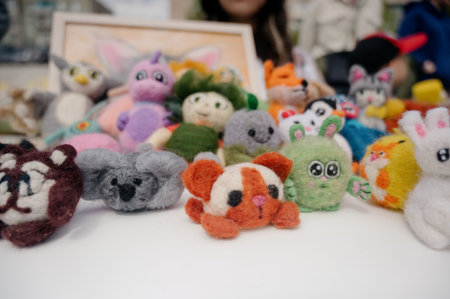 A collection of soft felt toys in the shape of animals. A close-up of handmade toys. Decorative...