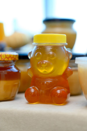 Honey and jam in glass jars.Close-up of jars of different types of honey on a counterの写真素材