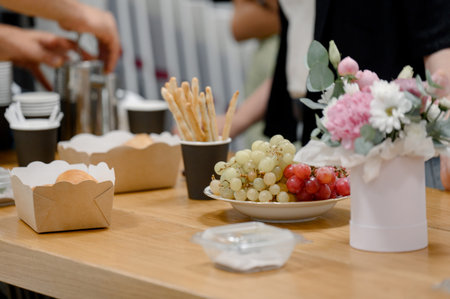 Close-up of a snack setting with red and green grapes in a business setting. Catering at an event...