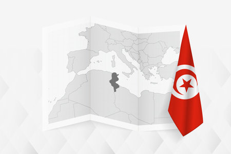 A grayscale map of Tunisia with a hanging Tunisian flag on one side. Vector map for many types of news. Vector illustration.のイラスト素材