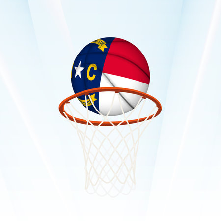 Vector illustration of a basketball styled with the national flag of North Carolina, captured in the moment of scoring through a hoop. Perfect for sports tournaments, international competitions.のイラスト素材