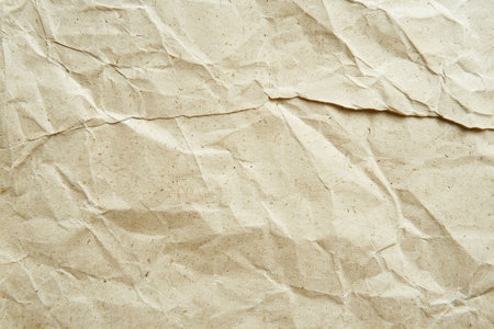 A close-up image of beige, crumpled paper with a textured surface.の素材