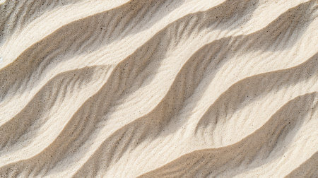 A close-up view of light brown sand dunes with a textured pattern of diagonal ripples created by wind erosion.の素材