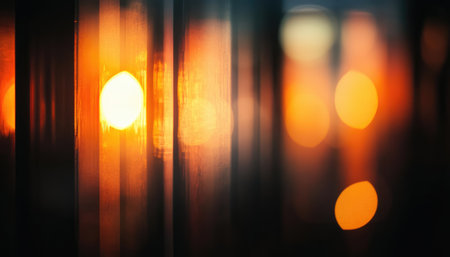 An abstract image of a sunset shining through window blinds, creating a blurred and warm glow.の素材