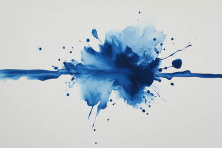 A close-up shot of a blue watercolor splatter and streak on a white paper background.の素材