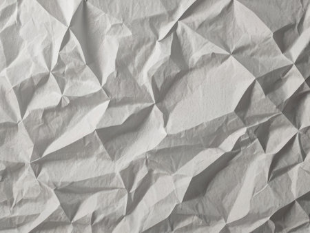 A close up image showcasing the texture of heavily crumpled white paper creating an abstract background.の素材