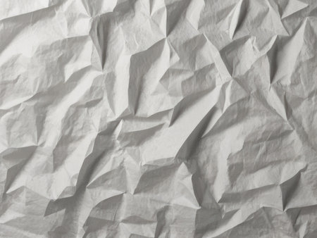 A close up image shows the texture of heavily crumpled gray paper creating an abstract background.の素材