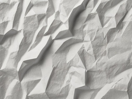 A close-up image shows the abstract texture of heavily crumpled white paper creating a visually interesting background.の素材