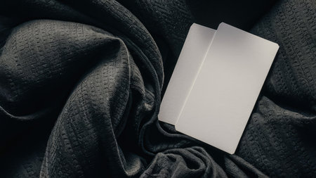 Blank business cards on black background. Mockup for branding identity.の素材