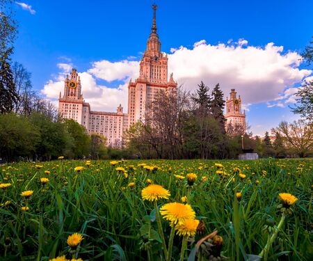 Sunset campus of Lomonosov Moscow State University under cloudy sky with yellow dandelionsのeditorial素材