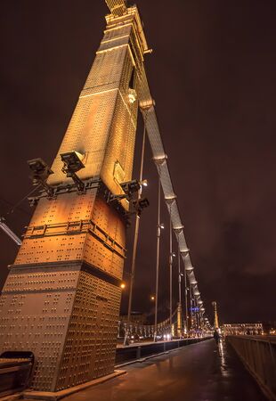 Night arch of illuminated Krymskiy bridge in Moscow