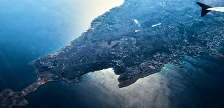 Aerial view of the Cyprus island surrounded by azure sea with waves, yacht, city relief and...