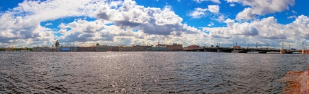 Daytime wide angle sunny panorama of Neva river in Saint Petersburg from embankment site under dramatic cloudsの写真素材