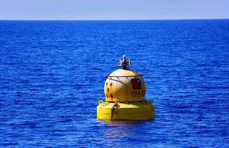 Glowing sunny warm waves of Cyprus  with nice sun reflections and sea buoyの写真素材