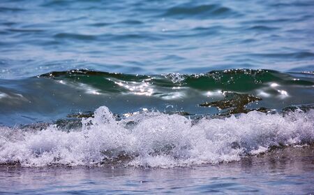 Glowing warm waves of Cyprus Larnaca with nice sun reflection stars