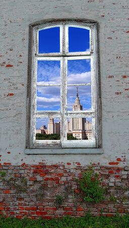 Nice summer view from retro window in the middle of  abandoned brick wall with growing green plants の写真素材