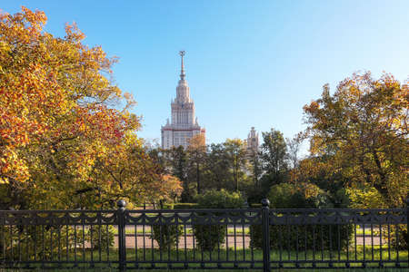 Golden trees in sunny autumn campus of old university in Moscow under blue skyの写真素材