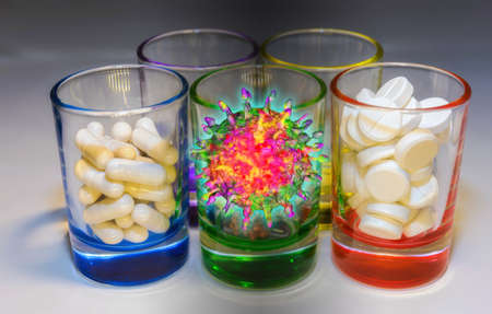 Five glasses with white pills and virus species on gray