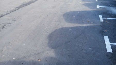 Background picture of dirty asphalt road with car shadowsの写真素材