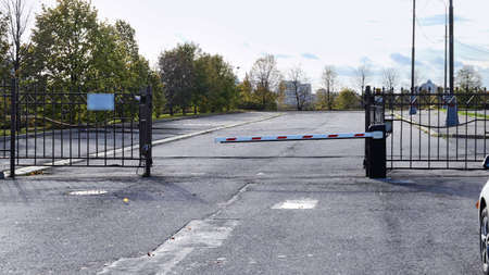 Car gate with barrier on asphalt road in campus of famous university in Moscow
