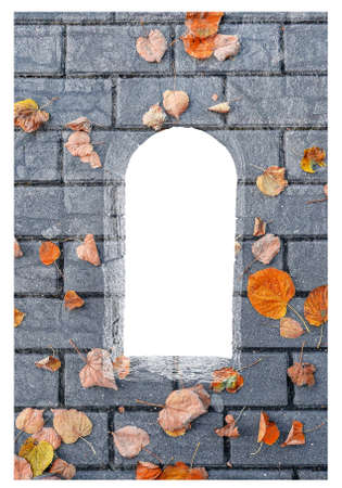 Silhouette of stone window filled with tile stones and fallen golden autumn leaves isolated on white backgroundの写真素材